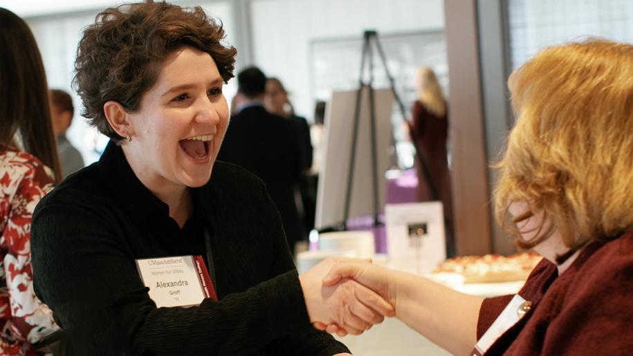 Alexandra Groff shaking hands with personat Conversations with Women of UMass event