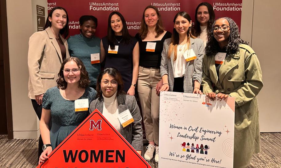 Group photo of women holding signs at a Women's Civil Engineering Leadership Summit
