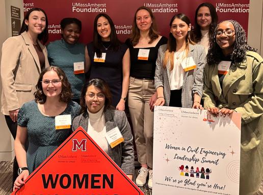 Group photo of women holding signs at a Women's Civil Engineering Leadership Summit
