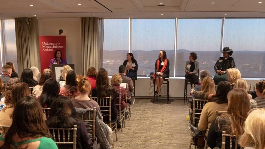 Audience listening to speakers at Women For UMass event.